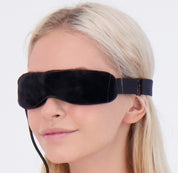 Close-up of blonde girl wearing Wizard Research electric heated eye mask for dry eye relief