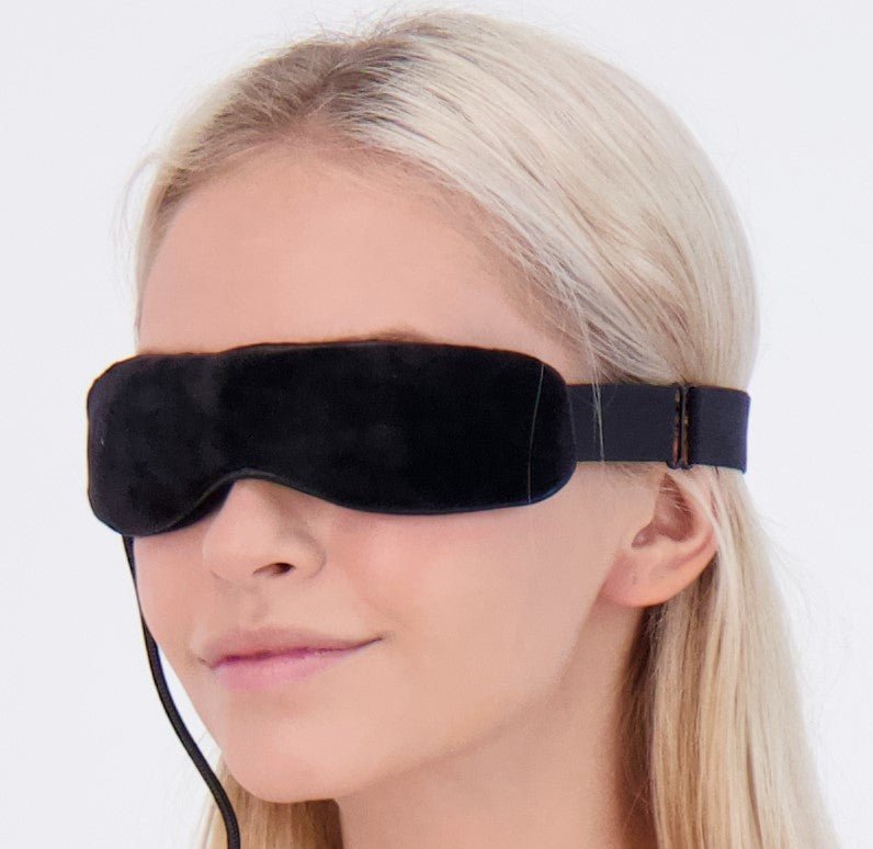 Close-up of blonde girl wearing Wizard Research electric heated eye mask for dry eye relief