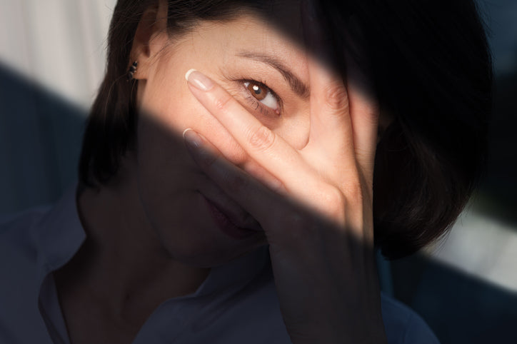 woman covering one eye
