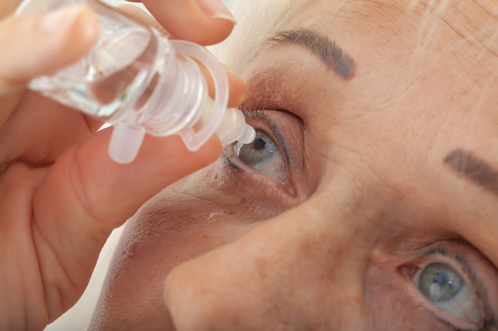 putting eye drops on eye