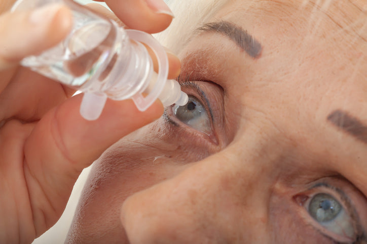 putting eye drops on eye