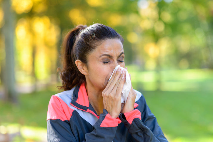 woman blowing her nose