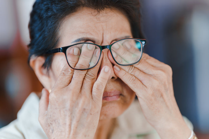 woman covering eyes