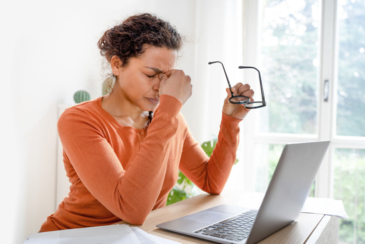 woman working on laptop with vision problems 