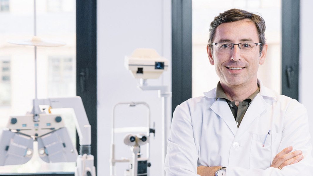 Smiling eye doctor in clinic featured on Wizard Research contact us banner for trusted dry eye care support