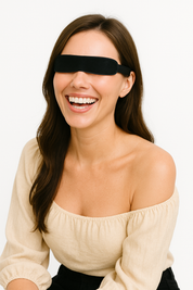 Smiling woman wearing the Wizard Research heated eye mask on a white background, dressed in an off-shoulder beige top